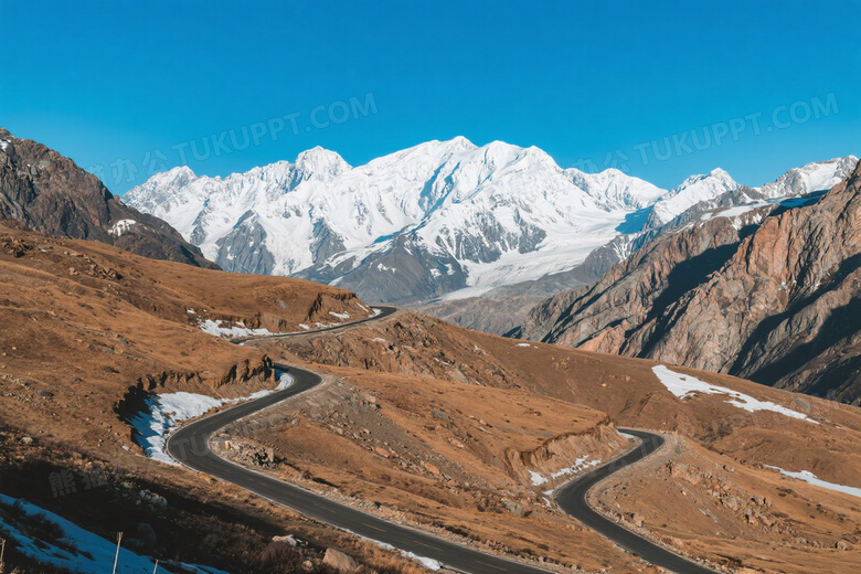 盘山公路穿行干枯山谷雪峰图片