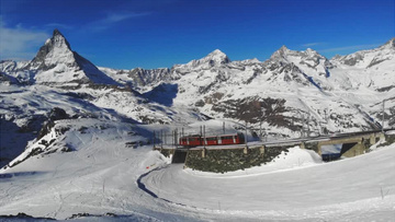 火车缓缓经过雪山实拍视频素材