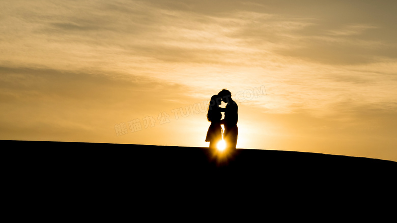 夕阳下拥抱的情侣剪影摄影图片