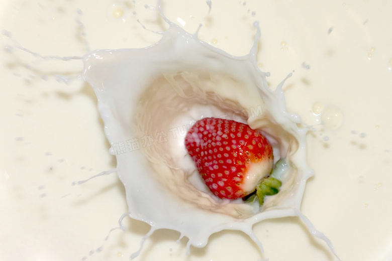 掉进牛奶里的草莓特写摄影高清图片