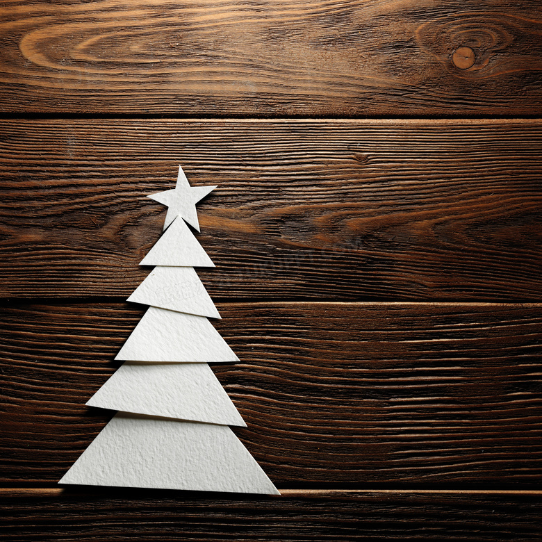 木板上厚纸板叠放的圣诞树高清图片