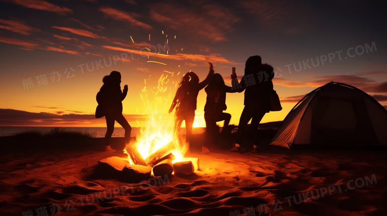 夜晚户外露营在篝火旁狂欢的朋友们摄影图