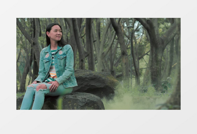  坐在石头上的牛仔女孩实拍视频素材