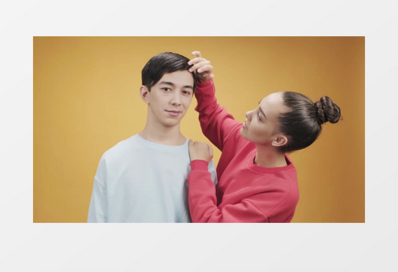 一个女人再给男人整理头发实拍视频素材