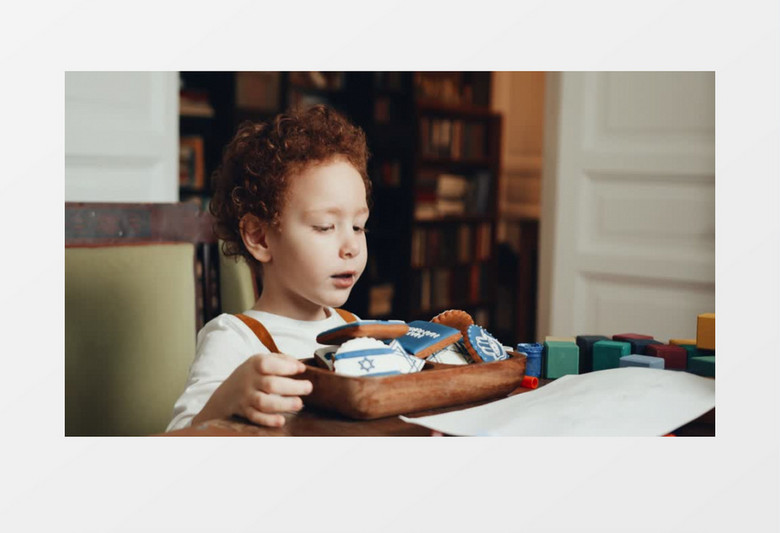 小男孩在吃桌子上的饼干实拍视频素材