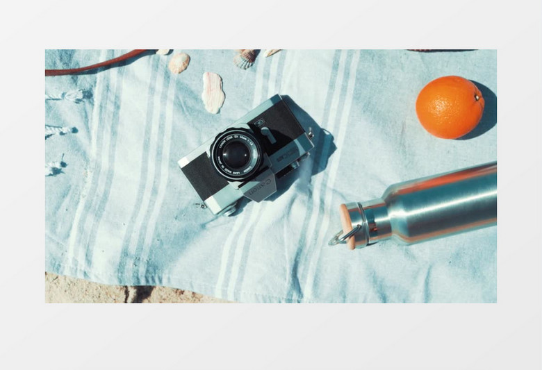 海边沙滩上的相机水壶实拍视频素材