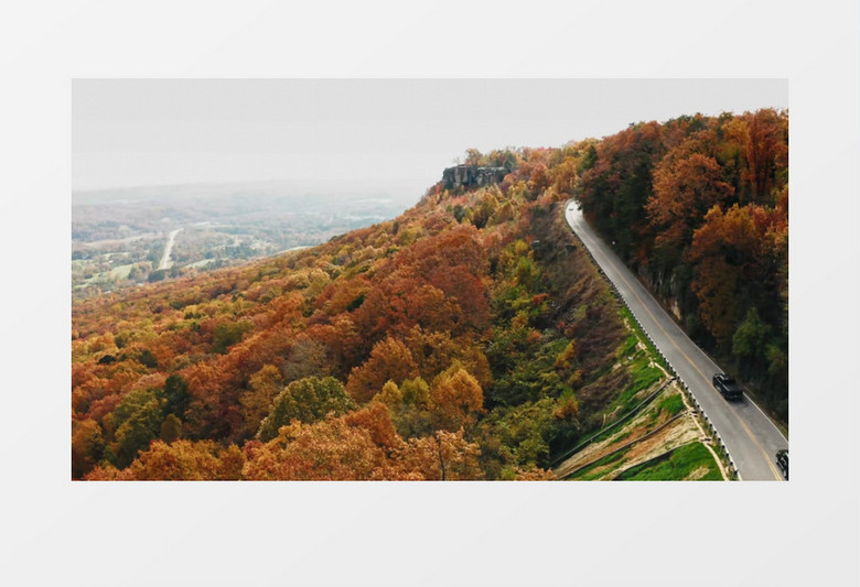 实拍被树木覆盖的山丘和半山腰的道路实拍视频素材
