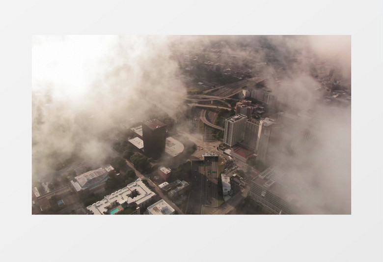 航拍云层笼罩下的城市建筑实拍视频素材