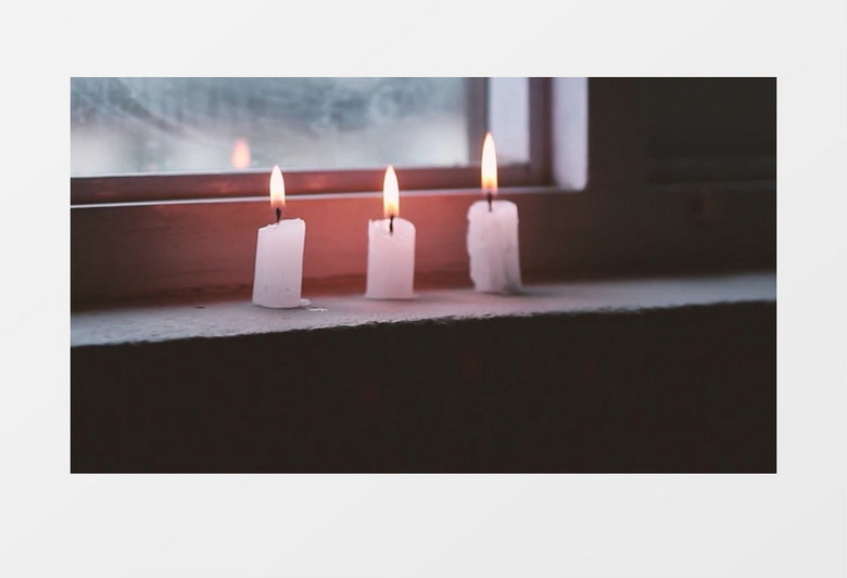 近距离拍摄男子吹灭窗台上燃烧的蜡烛实拍视频素材